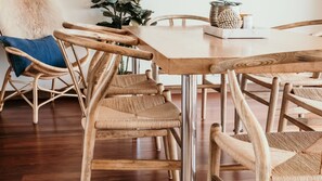 A dining area with a wooden table and chairs.