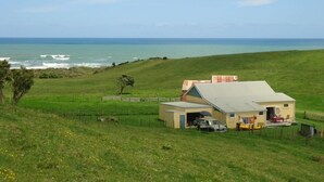 A coastal property with a large house, a garage, and a fenced yard.