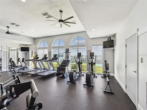 A modern gym with treadmills, elliptical machines, and free weights. - Belle Harbor 401W Belle Harbor Jewel (CLearwater Beach)