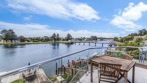 A riverside deck with outdoor seating and a view of the water. - The Moorings - Absolute River Frontage (Port Fairy)