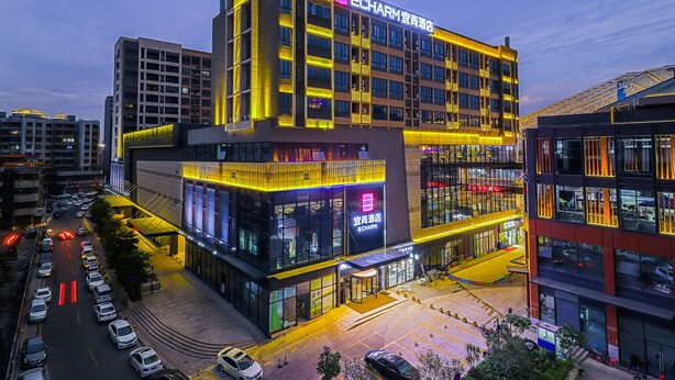 A multi-story building with a prominent ECHARM sign, large windows, and a parking area. - ECHARM HOTEL（Xi Qiao Shan, Foshan） (Foshan)