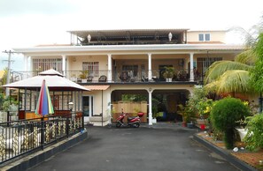 Guests can enjoy a covered entrance and a balcony on the upper floor.