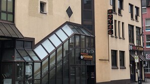 A hotel with a modern facade, large windows, and a restaurant sign. - Hotel & Restaurant Poseidon (Bayreuth)
