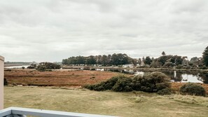 A view of a lake with trees and a building in the background. - Moyne Views 2 - Overlooking The Edge Of The Moyne River (Port Fairy)