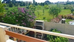 A balcony with a view of a green landscape, including trees and a building in the distance. - Sunny A/C apartment with terrace overlooking countryside and private pool (Saint-Pargoire)