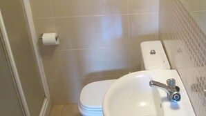 Ein Badezimmer mit Toilette, Waschbecken und Spiegel.