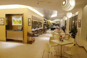 A hotel lobby with a reception desk, seating area, and a staircase leading to upper floors. - Jinjiang Inn (Baoding Junxiao Square) (Baoding)