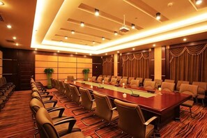 A conference room with a long table, chairs, and a modern ceiling design. - Zhuozheng International Hotel (Baoding)