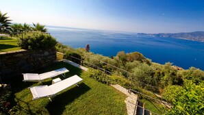 Una terraza con dos sillones de descanso con vistas a la costa.