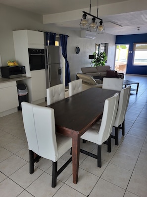 A modern kitchen with a dining area.