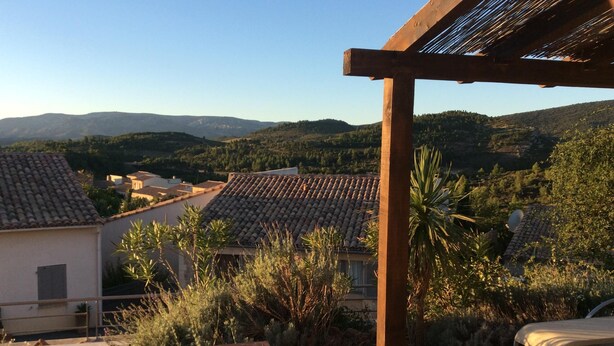 A terrace with a wooden pergola, a pool, and a view of a village with terracotta roofs and hills in the background. - Villa w/Lg Private Pool In Beautiful Languedoc-Roussillon Countryside-WiFi (Durban-Corbières)