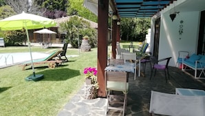 An outdoor patio with a pool, lounge chairs, and a covered seating area. - Charming chalet  with private pool and around to beaches (Espargo/Santa Maria da Feira)