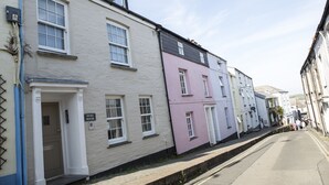 A row of traditional buildings with a sign reading "Duke House" on the white building.