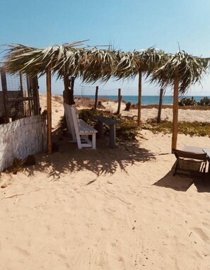 On the beach, sun-loungers