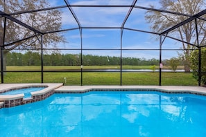 A swimming pool with a view of a lake and trees, enclosed by a metal fence. - Bluelakeview Villa – Private Pool, Spa & Panoramic Lake Views | BBQ & Games Room (Clermont)