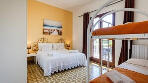 Habitación de hotel con literas, una cama individual y vistas al exterior.