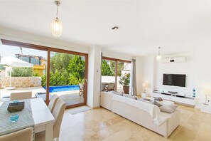 Flat-screen TV, DVD player, books, video library