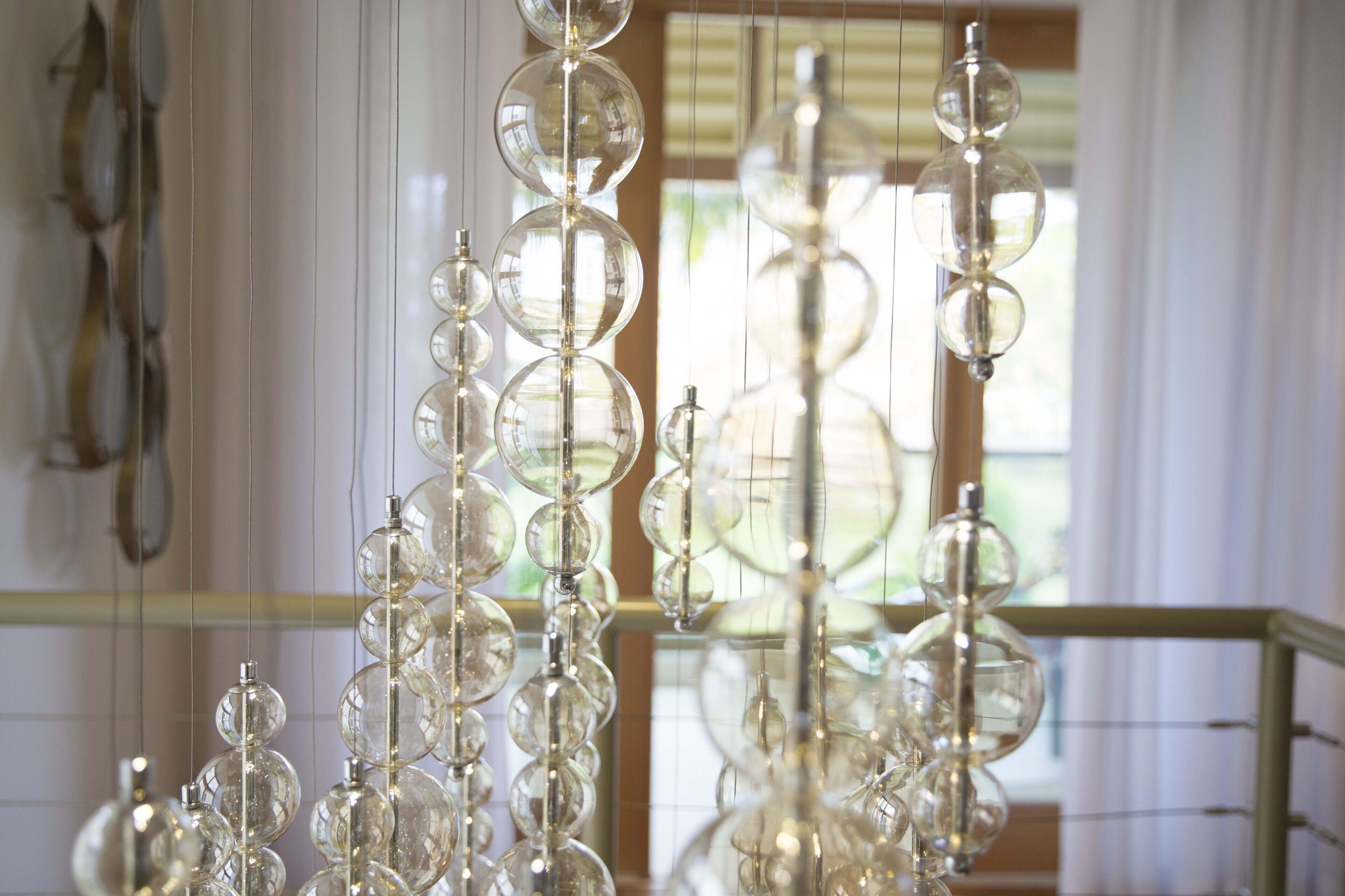 A chandelier with multiple spherical glass bulbs suspended from a central rod.