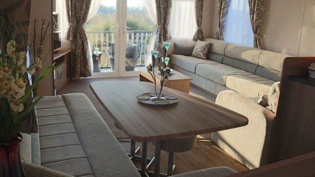 A cozy living area with a sofa, a dining table, and a bench.