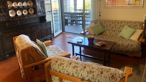 Un salon chaleureux avec une cheminée, un canapé, une table basse et une table à manger.
