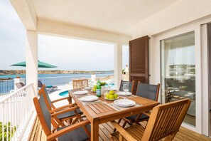 Enjoy al fresco dining on this terrace with a stunning coastal view.