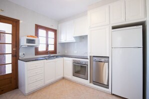 Enjoy cooking in this well-equipped kitchen with a microwave, oven, and dishwasher.