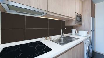 A modern kitchen with a built-in stove, sink, and dishwasher.