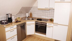 Una cucina compatta con lavastoviglie, forno e macchina per il caffè.