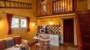 A cozy interior with a sofa, dining table, and kitchen area. - Charming cottages, private SPA and private garden (Bédoin)