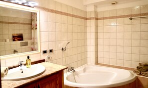 Bathtub, hair dryer, bidet, towels