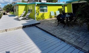 A dock with lounge chairs, a small building with a window, and a paved area. - FIFA World Cup 2026- Special Offer! (Matlacha)