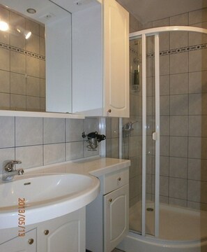 Shower, hair dryer, towels, toilet paper