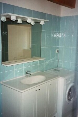 Bañera con ducha, secador de pelo, papel higiénico