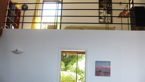 A room with a window, a door, and a painting on the wall. - In front... only the sea (Carqueiranne)