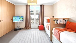 A hotel room with a TV, a bed, a bookshelf, a window with curtains, and a view of buildings. - Saint Tropez, exclusive apartment, heart of the village, Place de la Garonne. (Saint-Tropez)