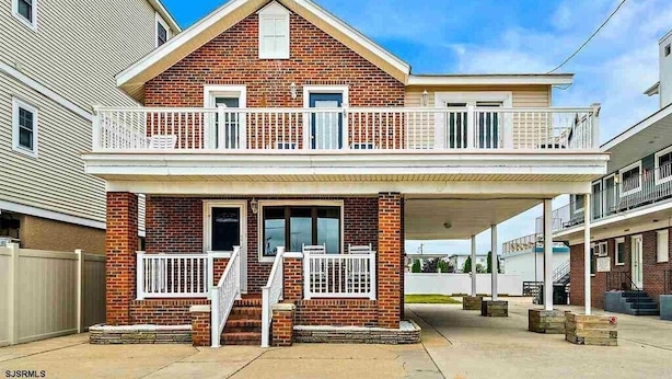 A two-story house with a balcony, a front porch, and a garage.