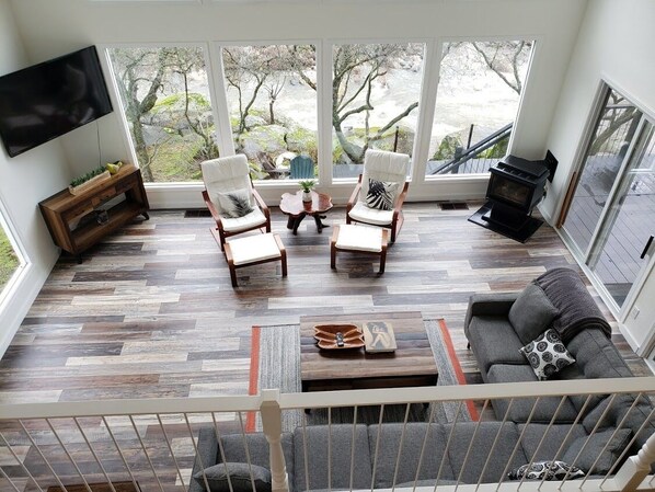 A living room with a fireplace, two armchairs, a sofa, and a coffee table. - "Sierra River House" on the Main Fork of the Kaweah River.  Breathtaking Views! (Three Rivers)