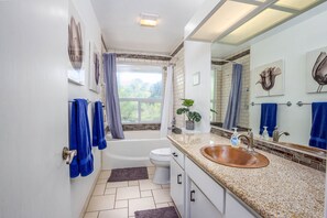 A bathroom with a bathtub, toilet, and sink. - "Sierra River House" on the Main Fork of the Kaweah River.  Breathtaking Views! (Three Rivers)