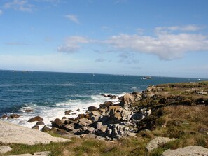A rocky coastline with the sea and a clear sky.