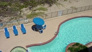 A swimming pool with a brick border, a hot tub, and lounge chairs. - Right Price in Paradise! Luxury Ocean Front (South Padre Island)