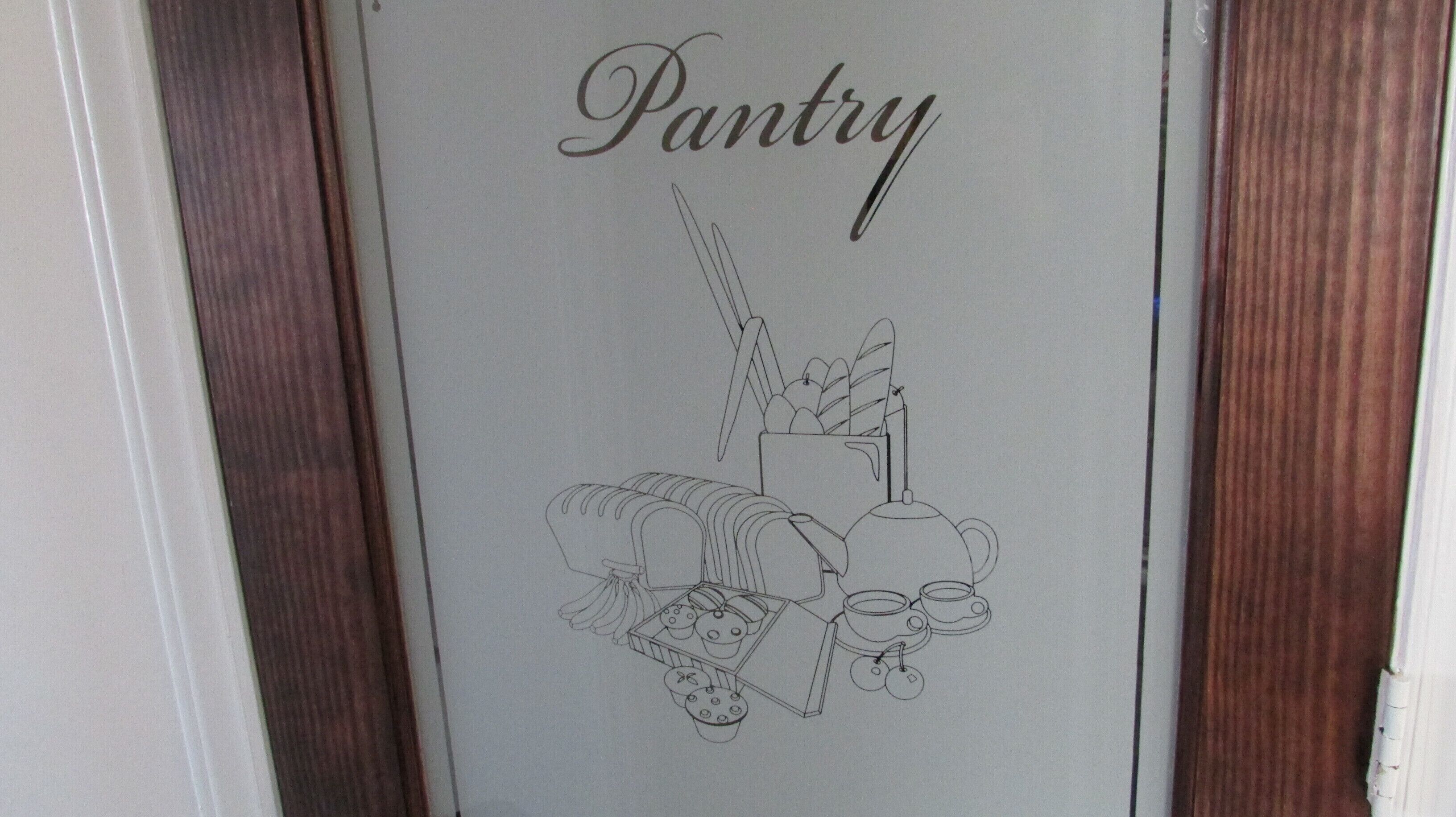 A door with a sign that reads "Pantry" and a simple line drawing of kitchen items.