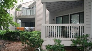 A two-story house with a covered porch and a fenced balcony. - Newly Updated, Near Harbour Town 1st Floor 2 Bedroom 2Bath  Villa  (Hilton Head Island)
