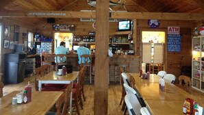 A restaurant with wooden interior, a bar area, and an ATM sign. - HONEYHOLE 3BR.  Beautiful, spacious, and best of all...NO BUNK BEDS! (Venice)