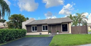 A two-story house with a front porch, a driveway, and a well-maintained lawn. - Lakeside Miami, Designed for Superior Comfort, close to everything Kendall (Miami)