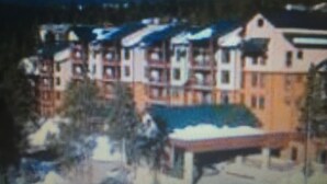 A building with a sloped roof, multiple windows, and a visible chimney. - Spend the week at Valdoro Mountain Lodge & quaint Breckenridge Village - (Breckenridge)