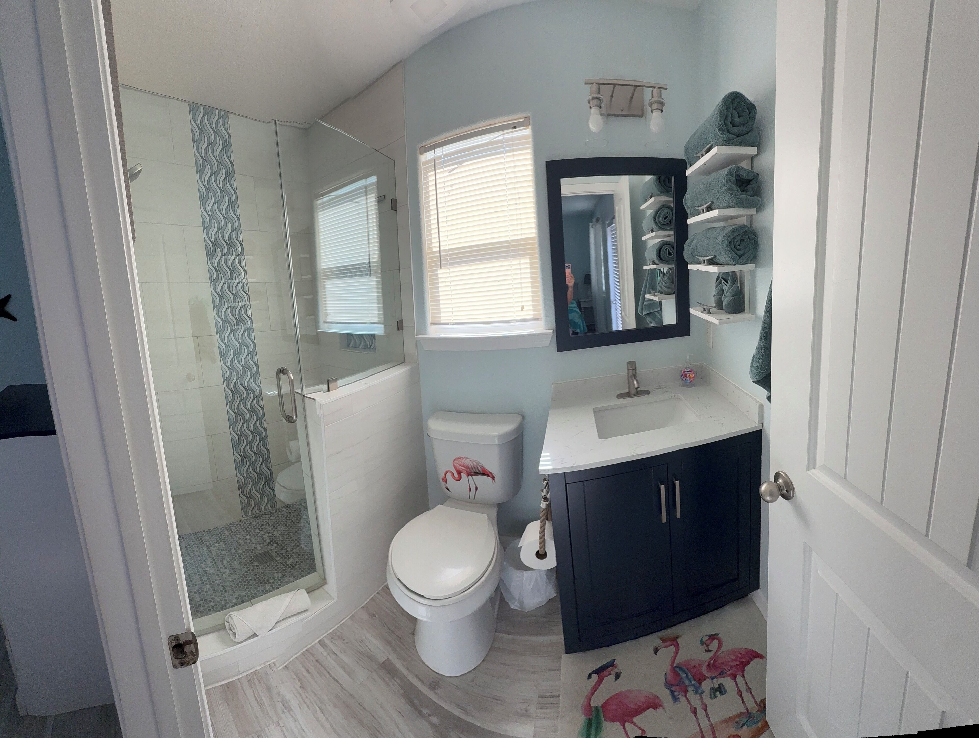 Bathtub, hair dryer, towels, toilet paper