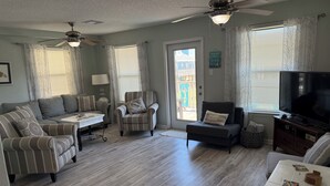 A living room with a sofa, armchairs, a coffee table, a TV, and a ceiling fan. - The Beach and Surf is Just Steps Away! (Surfside Beach)