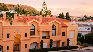 A building with a red-tiled roof, multiple windows, and a sign that reads "BALA DA LUZ". - Pure luxury - apartment in Baia da Luz Resort. Walk to beach. (Praia da Luz)