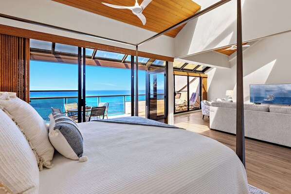 A bedroom with a large bed, a TV, a sofa, and a balcony with a view of the sea. -  Incredible Oceanfront Corner Penthouse, 3B/3Ba, 2700 sq ft, NEW remodel! (Lahaina, Maui)