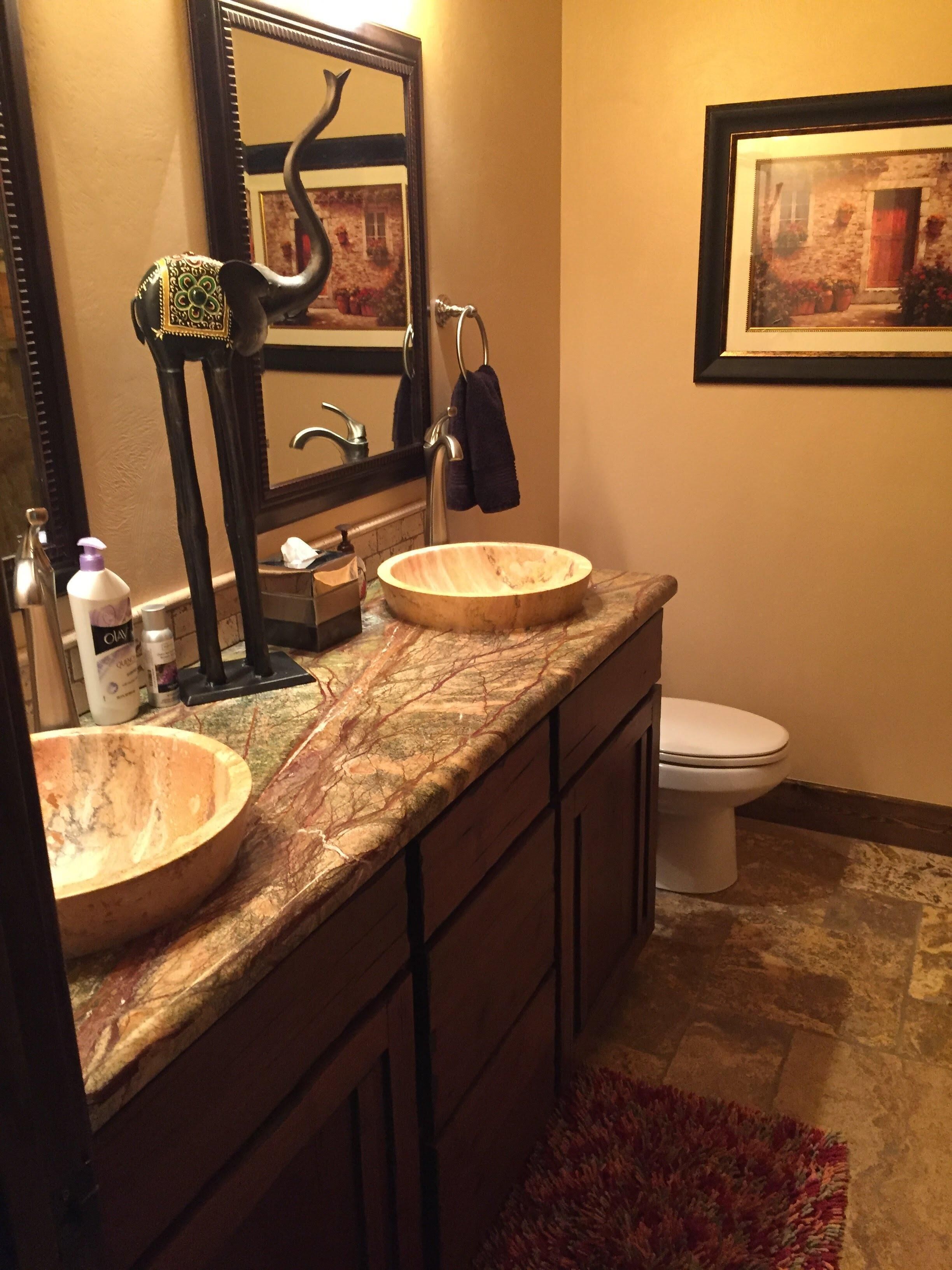 A bathroom with two wooden sinks, a mirror, and a toilet.